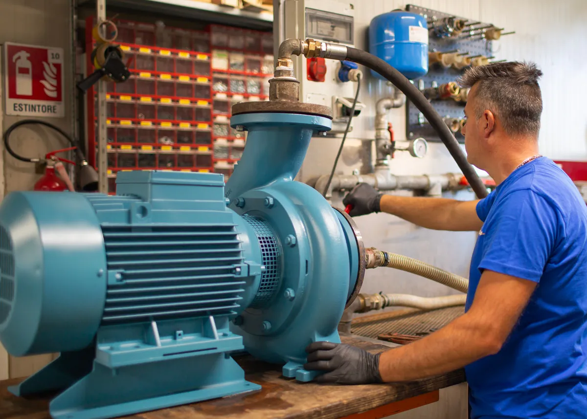 Tecnico Elettromec al lavoro su un'elettropompa di grandi dimensioni